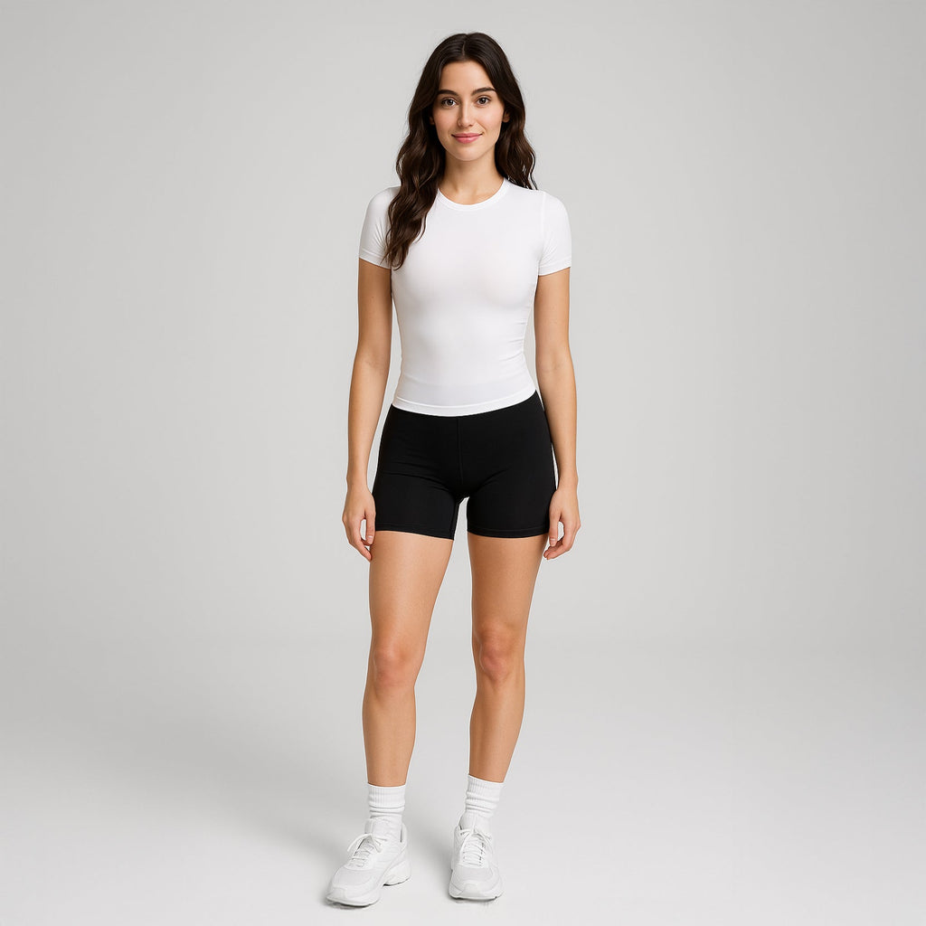 Model wearing the white OTL women's Everybody tee with black shorts