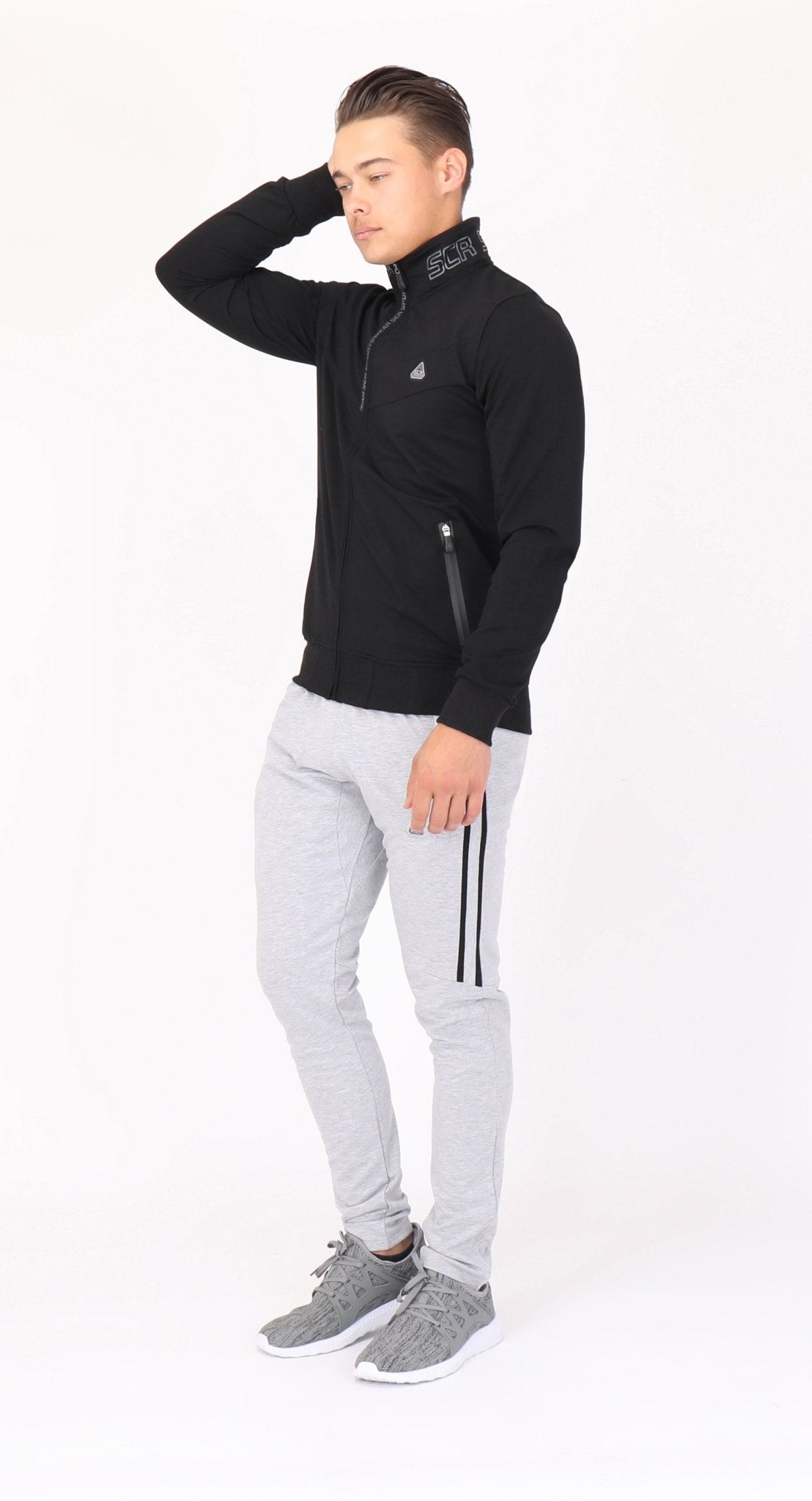 Model wearing the black SCR All-Day Comfort sweatshirt, full-length view