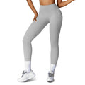 Model wearing light gray high-waist yoga leggings with white sneakers.